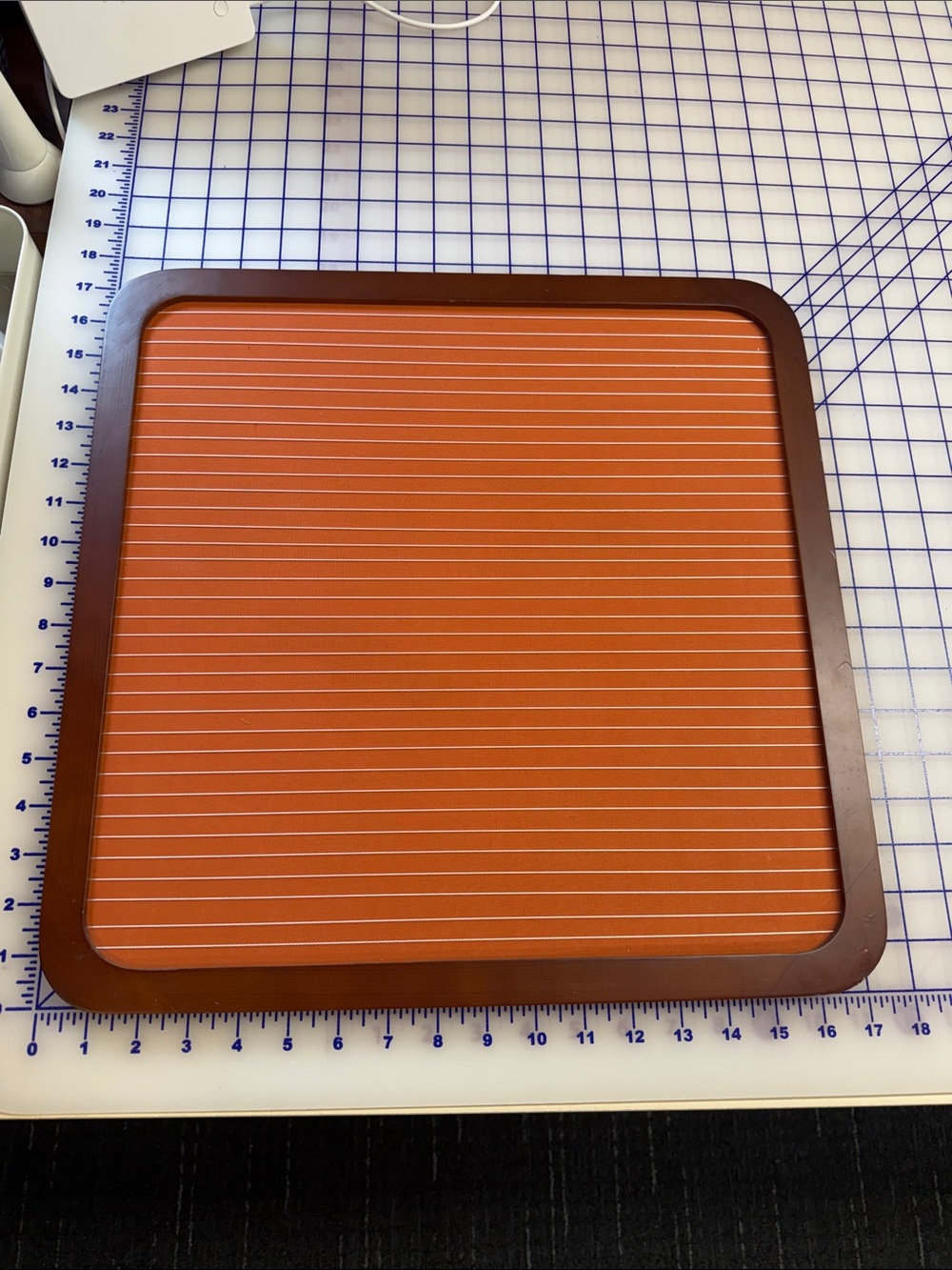 Memo Board orange horizontal string in a dark wood frame 17” square